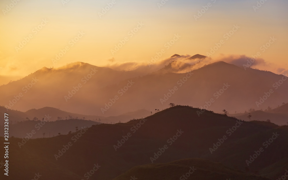 Beautiful mountain with cloud and sunrise at Tong Pa Phum national park ,Thailand. Landscape of the misty mountain covered on a hilltop at rural Thailand.