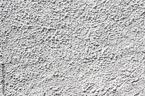 Light grey stucco decorated exterior wall texture background