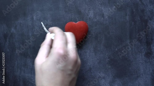 Hand writes with chalk 