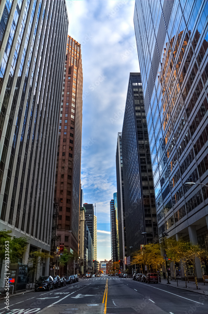 Narrow empty street of financial district, surrounded by skyscrapers in the morning, Manhattan, New York city, USA