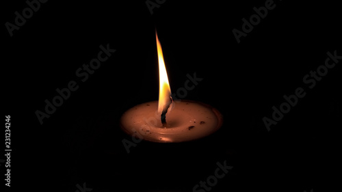 One butter lamp candle glowing in the dark, mainly used during Diwali or Deepawali festival