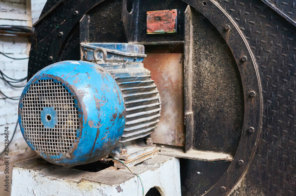 Old scratched and rusty electric motor. Industrial background. Old scratched and rusty electric motor. Industrial background.