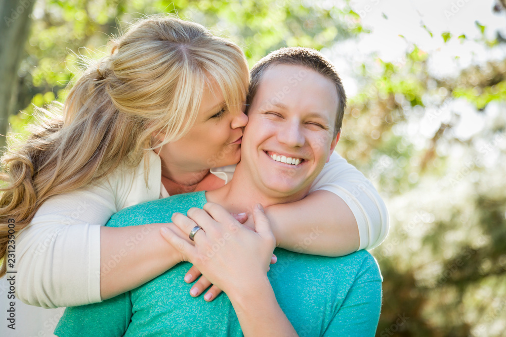 Young Attractive Couple Hugging in the Park Young Attractive Couple Hugging in the Park