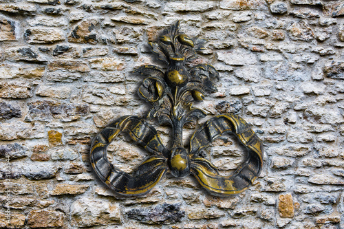 Bronze minted monogram on the background of the old fortress wall photo