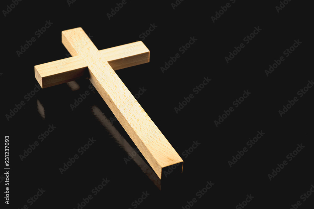 Wooden illuminated cross on a black background