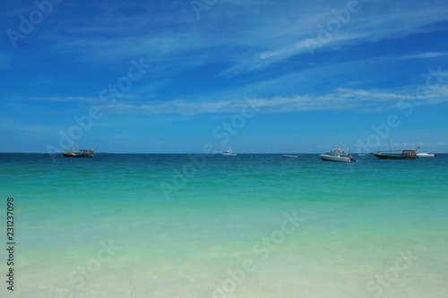 Ships and fishing boats in the blue ocean near Zanzibar island © stockmaliavanne
