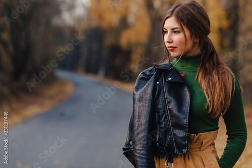 cozy stylish young girl walk at autumn colorful park