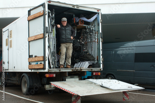 man in a truck with movie equipment