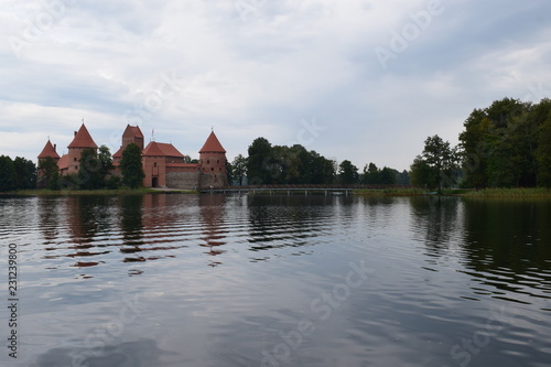 Trakai island castle at the lake. Reflection in water.