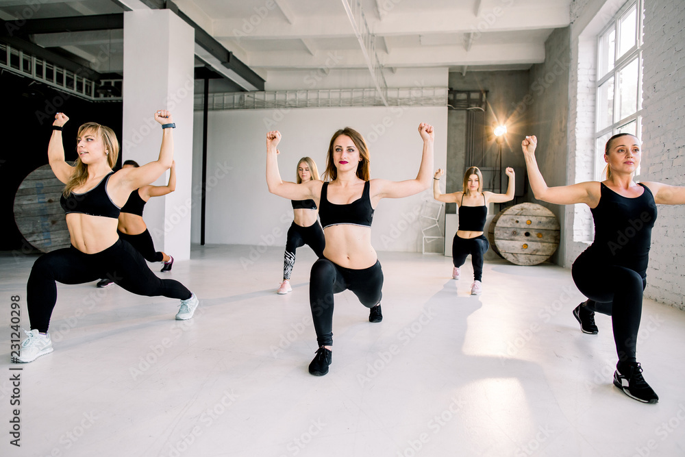 Fototapeta premium Young slim athletic females dancing strip plastic in class