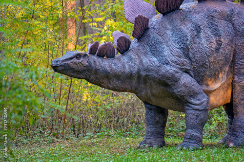 Fototapeta Naklejka Na Ścianę i Meble -  Big model of prehistoric dinosaur in nature. Realistic scenery.