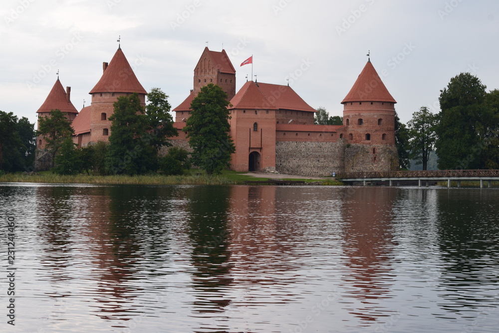 Trakai island castle at the lake. Reflection in water.