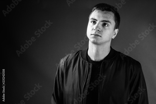 Studio shot of young handsome man in black and white
