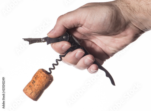 Male hand opens a bottle of wine. Cork and corkscrew.