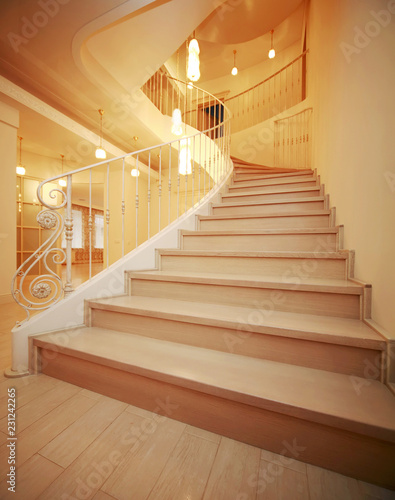wonderful and very cozy spacious house of several floors with a beautiful wooden staircase and carved railing, with a fireplace and a white chandelier