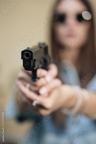 girl with a gun on the street learns to shoot