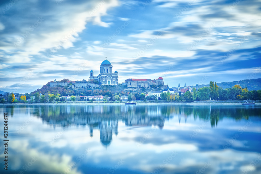 Estergom, Hungary, Europe. Basilica of the Blessed Virgin Mary. Amazing morning view over Danube river, beautiful reflections mirrored in water. Long exposure landscape. Blue color in nature.