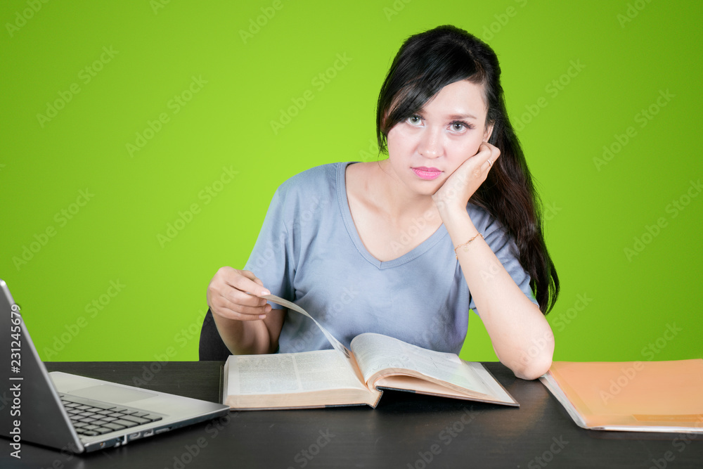 Student reading book and staring at camera Student reading book and staring at camera