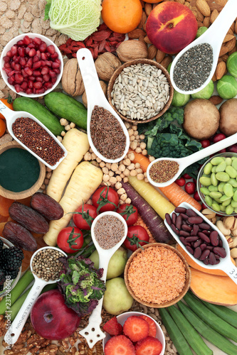 Health food for a high fibre diet with fruit, vegetables, legumes, nuts, seeds and cereals. Foods with antioxidants, anthocyanins, vitamins and minerals. Top view.