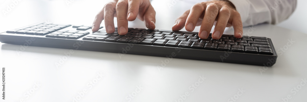 Wide view image of programmer using computer keyboard Wide view image of programmer using computer keyboard