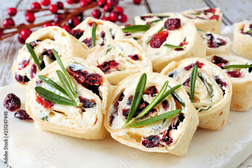Cranberry, cream cheese pinwheel appetizers. Holiday food concept. Close up, on a white background.