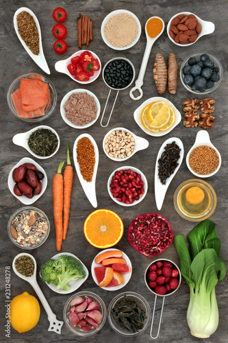 Food selection to slow the ageing process concept with super foods very high in antioxidants, anthocyanins, dietary fibre and vitamins. Top view on marble background.