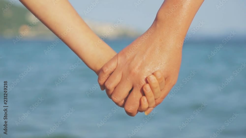Mother holding hand of her daughter on vacation. Mother holding hand of her daughter on vacation.