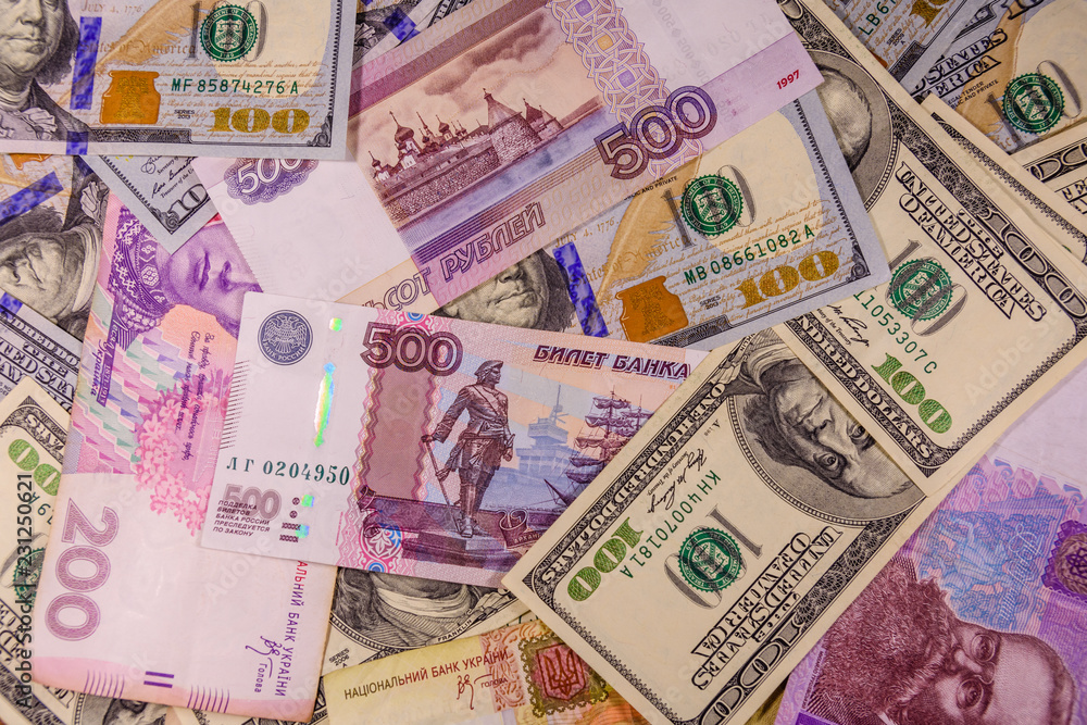 Obraz premium Background of the different american, ukrainian and russian banknotes