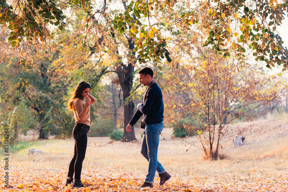 Couple having a leaf fight smiling and enjoying their time. Couple having a leaf fight smiling and enjoying their time.