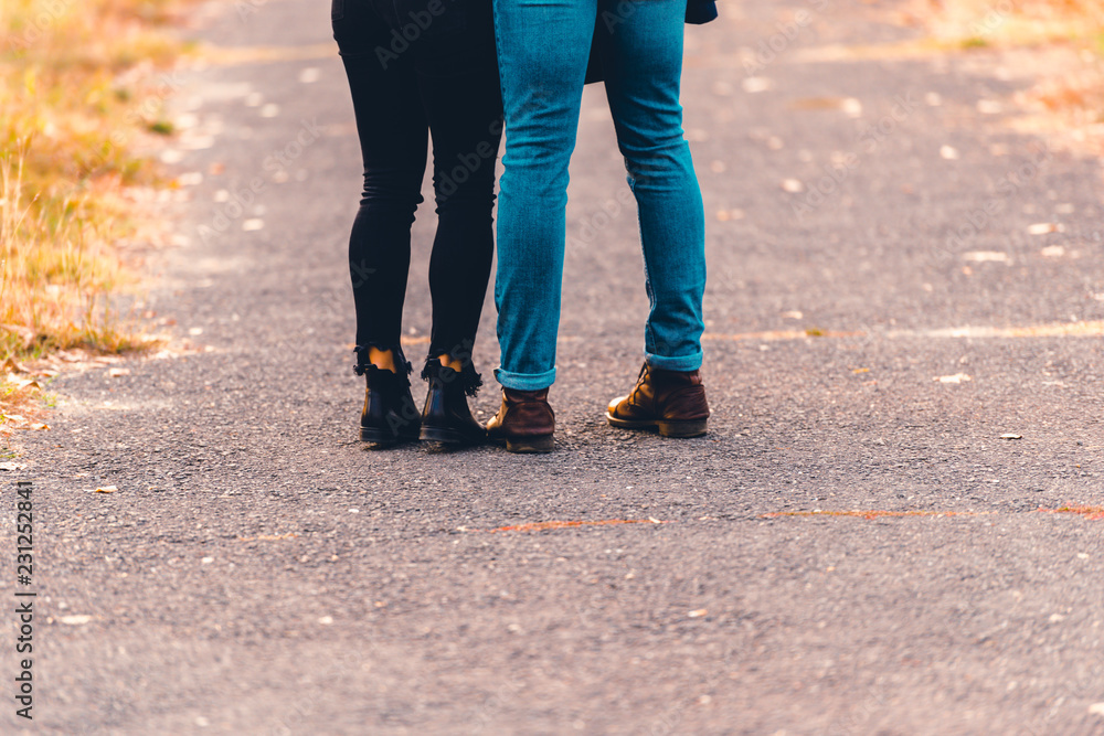 Boots and jeans,couple walking in the park.