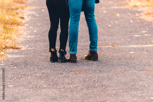 Boots and jeans,couple walking in the park.