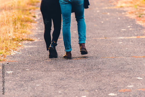 Boots and jeans,couple walking in the park. © qunica.com
