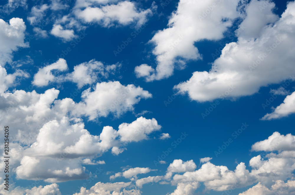 Naklejka premium blue sky background with white clouds