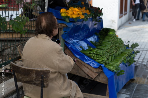the woman choose fresh cucumber in the market.healthy vegetables for illness. 
