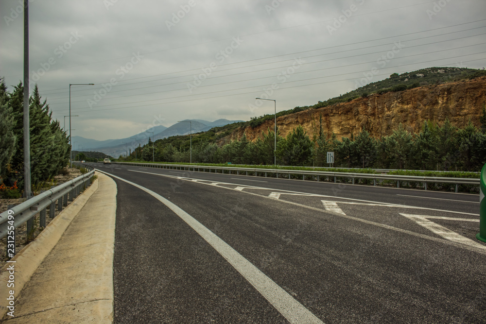 Fototapeta premium dry highway car road on mountain horizon background in evening time before sunset