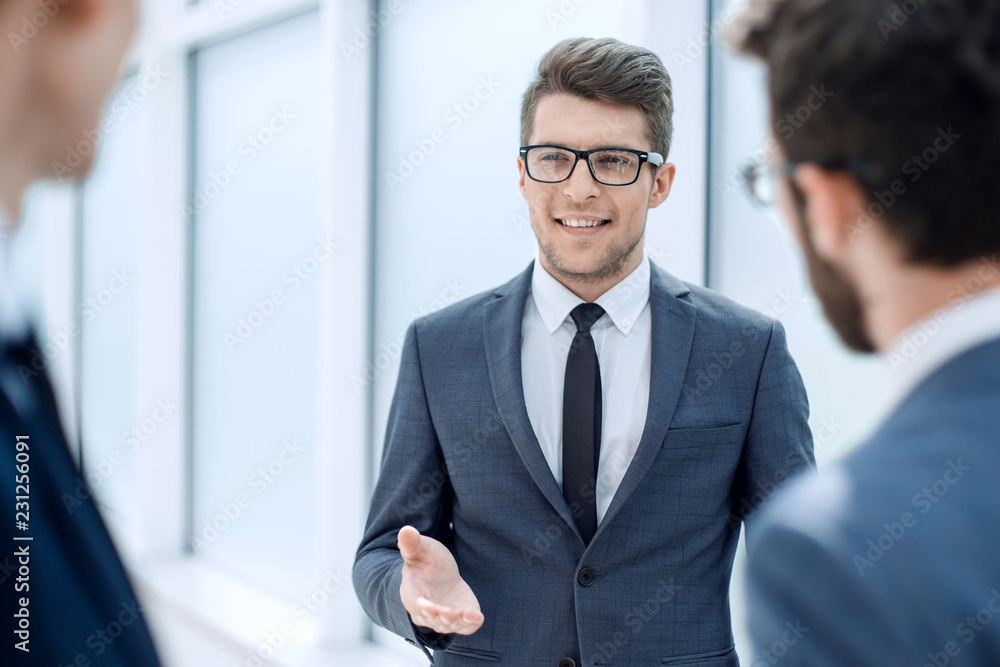 boss talking to employees standing in the office boss talking to employees standing in the office