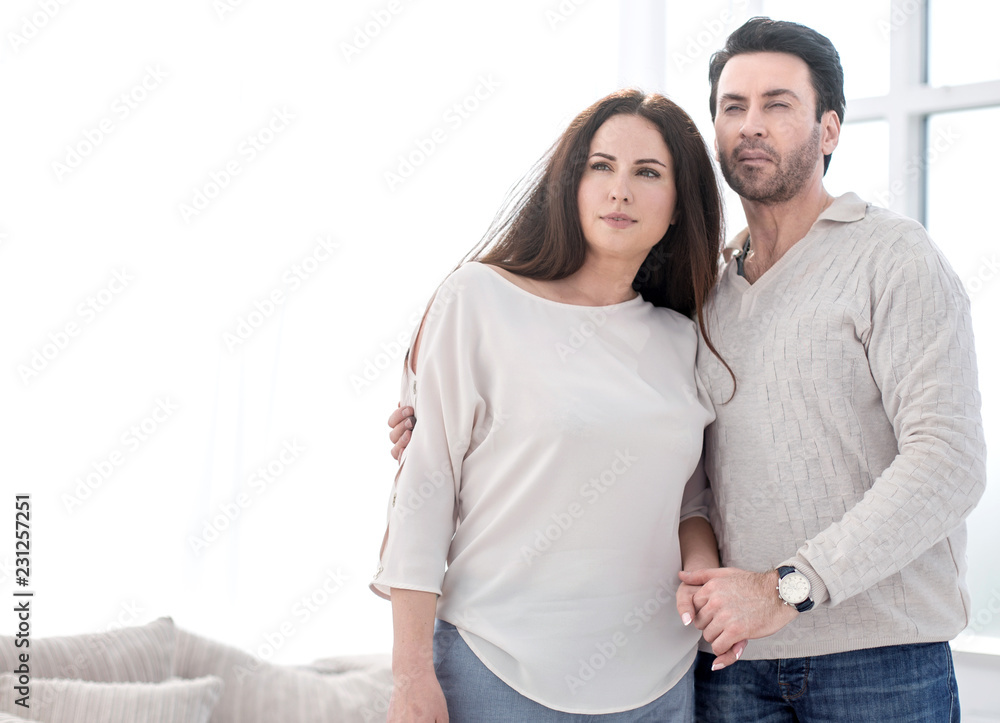 young married couple standing in new living room young married couple standing in new living room