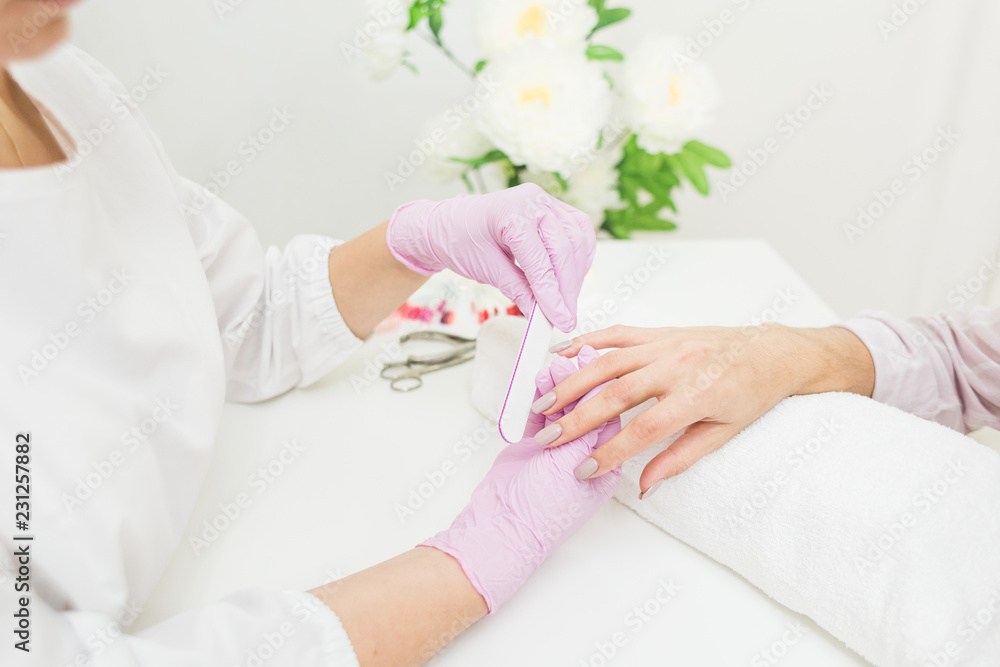Young woman getting manicure in beauty salon. Close-up Young woman getting manicure in beauty salon. Close-up