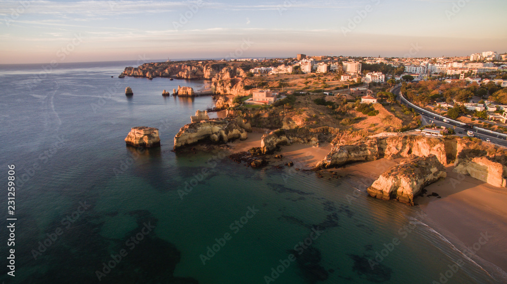 Aerial view of beautiful cliffs and beach near Lagos, Algarve, Portugal at sunrise