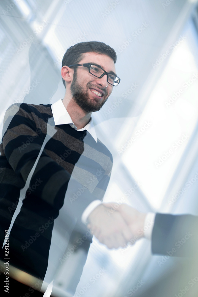 from behind the glass.handshake business people from behind the glass.handshake business people