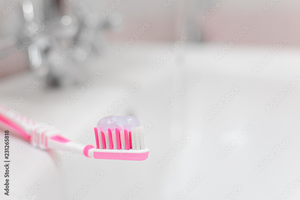 Pink toothbrush with toothpaste. Small depth of field. Pink toothbrush with toothpaste. Small depth of field.