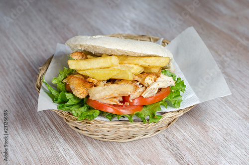 chicken sandwich with potatoes