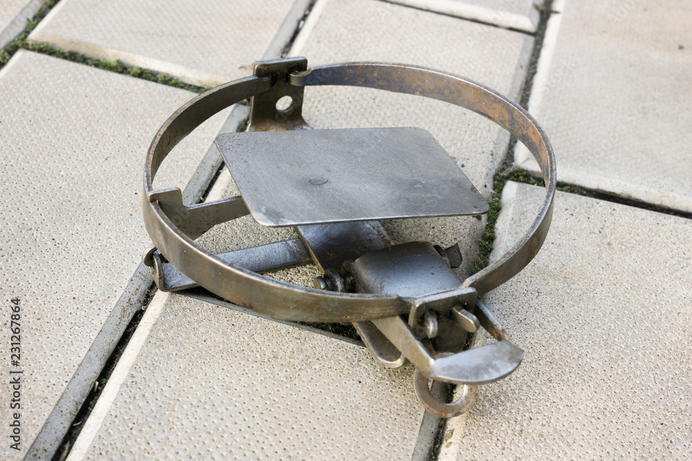 One rusty iron trap lying on stone floor