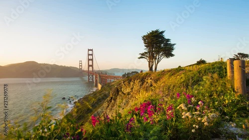 Beautiful Golden Gate Bridge and car traffic seen from cliffs above scenic Fort Point Rock toward Marin in this day to night time-lapse at San Francisco, California. 4k 30fps zoom out