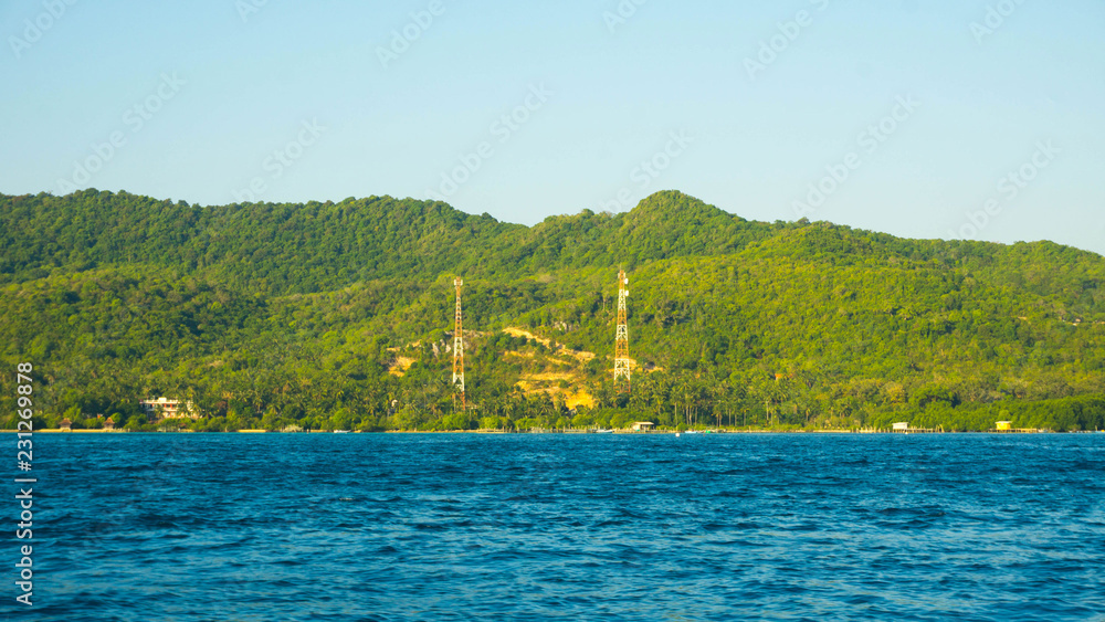 mosque in island big green with deep blue dark sea view in distance in karimun jawa