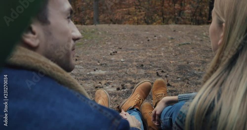 Wallpaper Mural Close up of the back view on the young romantic couple sitting at the tent in the wood and looking at each other with love. At fall. Outdoor. Torontodigital.ca