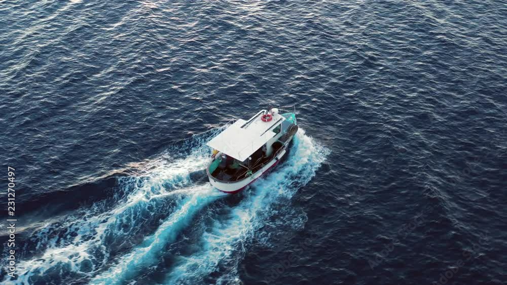 Video from above, aerial view of a beautiful fishing boat that sails in the Mediterranean sea. Sardinia, Italy. Video from above, aerial view of a beautiful fishing boat that sails in the Mediterranean sea. Sardinia, Italy.