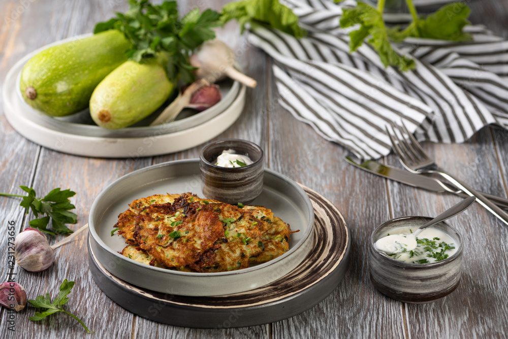 zucchini fritters on wooden table