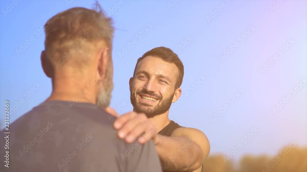 The happy son and a father talking outdoor. slow motion The happy son and a father talking outdoor. slow motion