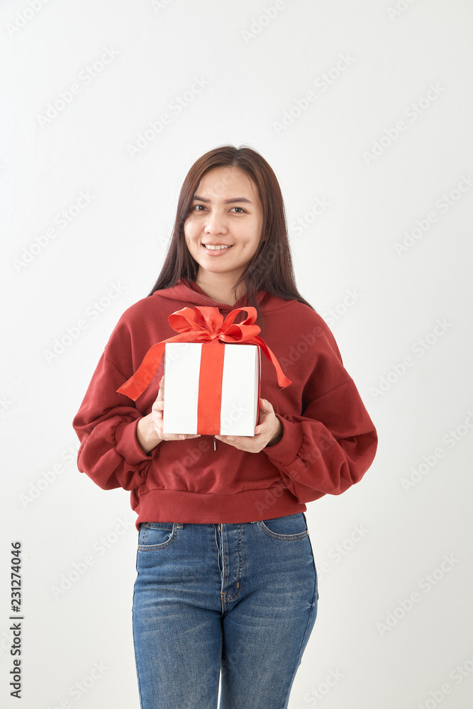 Fototapeta premium Young woman happy hold gift box in hands
